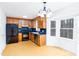 Well-lit kitchen with wood cabinets, black appliances, and a bright breakfast nook at 12491 Buffalo Rd, Archer Lodge, NC 27527