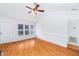 Spacious living area featuring hardwood floors, white walls, large windows, and vaulted ceiling at 12491 Buffalo Rd, Archer Lodge, NC 27527