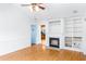 Bright living room with hardwood floors, fireplace, built-in shelving, and white walls at 12491 Buffalo Rd, Archer Lodge, NC 27527