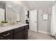 Bathroom showcasing a vanity with a quartz countertop and tiled floors, with a view into the marble shower at 170 Pine Cone Loop, Pittsboro, NC 27312