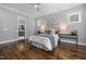 Cozy main bedroom with hardwood floors, natural light, en-suite access, and stylish decorations at 170 Pine Cone Loop, Pittsboro, NC 27312