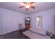 Bright bedroom featuring hardwood floors, two windows, ceiling fan, and interior door at 1805 Shelton Ave, Durham, NC 27707