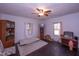 Bright bedroom featuring hardwood floors, two windows, ceiling fan, and room for relaxing at 1805 Shelton Ave, Durham, NC 27707