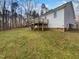 Exterior view of the deck, stairs, and backyard with grass and trees in the background at 20 Beechnut Ct, Franklinton, NC 27525