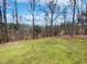 A lush backyard with grass and trees creates a private outdoor space at 20 Beechnut Ct, Franklinton, NC 27525