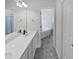 Elegant bathroom featuring double sinks, modern faucets, and a separate tub area, providing a spa-like experience at 20 Beechnut Ct, Franklinton, NC 27525