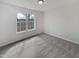 This vacant bedroom includes a large window overlooking the backyard at 20 Beechnut Ct, Franklinton, NC 27525