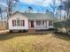 Charming single-story home featuring a welcoming front porch and a red front door, exuding warmth and curb appeal at 20 Beechnut Ct, Franklinton, NC 27525