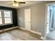 Bedroom with gray and blue walls, ceiling fan and wood-look flooring at 201 W Thorndale Dr, Oxford, NC 27565