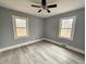 Bedroom featuring neutral paint, ceiling fan and wood-look flooring at 201 W Thorndale Dr, Oxford, NC 27565