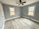 Bedroom featuring neutral paint, ceiling fan and wood-look flooring at 201 W Thorndale Dr, Oxford, NC 27565