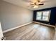 Bedroom with gray walls, ceiling fan, and wood-look flooring at 201 W Thorndale Dr, Oxford, NC 27565