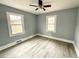 Bedroom featuring neutral paint, ceiling fan and wood-look flooring at 201 W Thorndale Dr, Oxford, NC 27565
