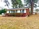 Exterior view showcasing brick and vinyl siding at 201 W Thorndale Dr, Oxford, NC 27565