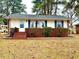 Exterior elevation featuring blue shutters and a brick foundation at 201 W Thorndale Dr, Oxford, NC 27565