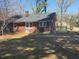 Rear exterior showcasing the brick facade, backyard, and new back patio at 201 W Thorndale Dr, Oxford, NC 27565