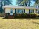 Charming front exterior with brick foundation, green shutters, and well-maintained lawn at 201 W Thorndale Dr, Oxford, NC 27565