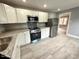 Open concept kitchen with stainless steel appliances and modern countertops at 201 W Thorndale Dr, Oxford, NC 27565