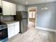 Corner of kitchen featuring stainless steel appliances and adjacent dining area at 201 W Thorndale Dr, Oxford, NC 27565