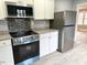 Close-up of the kitchen featuring stainless steel appliances and modern cabinetry at 201 W Thorndale Dr, Oxford, NC 27565