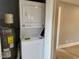 Close-up of a modern stacked washer and dryer with a water heater at 201 W Thorndale Dr, Oxford, NC 27565