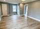 Spacious living room with wood-look flooring, a bright window, and neutral paint at 201 W Thorndale Dr, Oxford, NC 27565