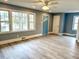 Spacious living room with hardwood floors, large windows, and modern ceiling fan at 201 W Thorndale Dr, Oxford, NC 27565