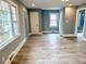 Bright living room featuring hardwood floors, freshly painted walls, and large windows at 201 W Thorndale Dr, Oxford, NC 27565