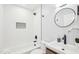 Modern bathroom featuring a tiled shower-tub combination and a sleek vanity sink offering a clean and stylish design at 202 W Lavender Ave, Durham, NC 27704