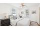 Cozy bedroom featuring a queen-sized bed, soft lighting, neutral walls, and hardwood floors creating a serene retreat at 202 W Lavender Ave, Durham, NC 27704
