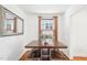 Inviting dining room with wooden table and seating, brightened by natural light from the window and a reflective mirror at 202 W Lavender Ave, Durham, NC 27704