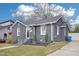 Charming single story brick home with driveway, manicured lawn, and walkway at 202 W Lavender Ave, Durham, NC 27704