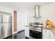 Bright kitchen with stainless appliances, granite countertops, and subway tile backsplash at 202 W Lavender Ave, Durham, NC 27704
