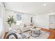 Bright living room with hardwood floors, large windows, and neutral furniture at 202 W Lavender Ave, Durham, NC 27704