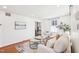 Bright living room with hardwood floors, large windows, and neutral furniture at 202 W Lavender Ave, Durham, NC 27704