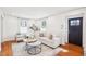Bright living room with hardwood floors, large windows, and neutral furniture at 202 W Lavender Ave, Durham, NC 27704