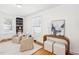 Cozy living room featuring comfortable armchairs, stylish decor, natural light, and hardwood floors enhancing a relaxing ambiance at 202 W Lavender Ave, Durham, NC 27704