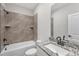 Updated bathroom with a shower-tub combo and granite vanity at 203 Jetson Creek Way, Youngsville, NC 27596