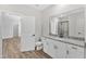 Bathroom features a toilet, vanity with granite counters, and a modern mirror at 203 Jetson Creek Way, Youngsville, NC 27596