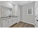 Bathroom vanity with granite counters, white cabinets, and sleek hardware at 203 Jetson Creek Way, Youngsville, NC 27596