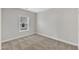 Neutral-painted bedroom with carpet flooring and natural light from window at 203 Jetson Creek Way, Youngsville, NC 27596