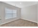 This carpeted bedroom has neutral paint and a window at 203 Jetson Creek Way, Youngsville, NC 27596