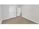 Bright, carpeted bedroom with neutral walls, two interior doors, and crisp, white trim at 203 Jetson Creek Way, Youngsville, NC 27596
