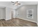 Bright bedroom features neutral walls, wood flooring, and a ceiling fan at 203 Jetson Creek Way, Youngsville, NC 27596