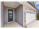This home has an elegant dark door and garage with beautiful stone accents at 203 Jetson Creek Way, Youngsville, NC 27596