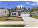 Charming single-Gathering home with a two-car garage and well-manicured lawn and Autumn foliage at 203 Jetson Creek Way, Youngsville, NC 27596