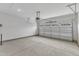 Spacious two car garage with neutral walls and a large garage door with window inserts at 203 Jetson Creek Way, Youngsville, NC 27596