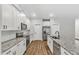 Well-equipped kitchen with stainless appliances, granite counters, and white cabinetry at 203 Jetson Creek Way, Youngsville, NC 27596