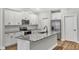 Stylish kitchen with granite counters, stainless appliances, and white cabinets at 203 Jetson Creek Way, Youngsville, NC 27596
