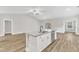Kitchen island with granite countertop and stainless steel dishwasher at 203 Jetson Creek Way, Youngsville, NC 27596